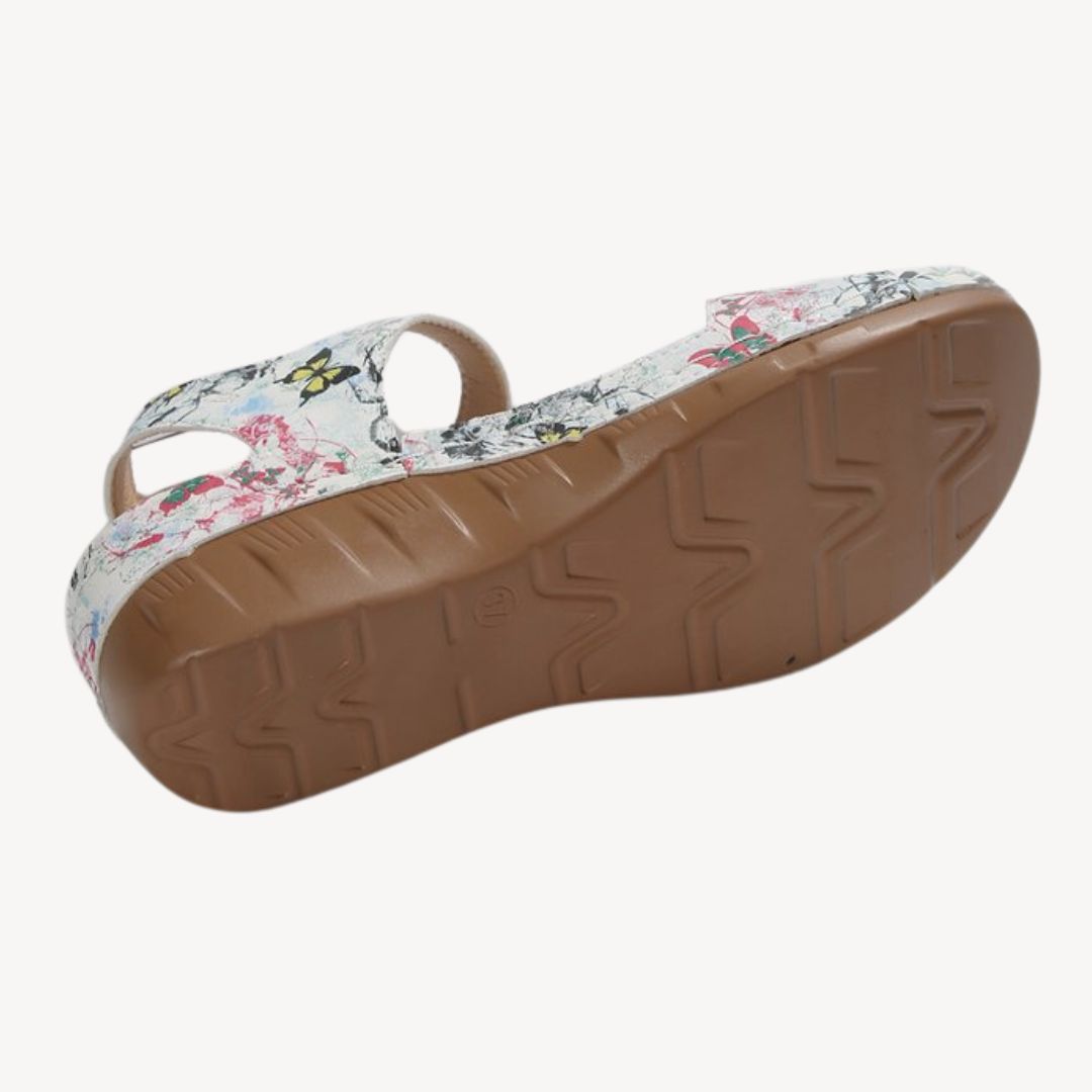 Black women's leather orthopedic sandals with adjustable Velcro straps, low wedge heel, and flexible sole for comfort.