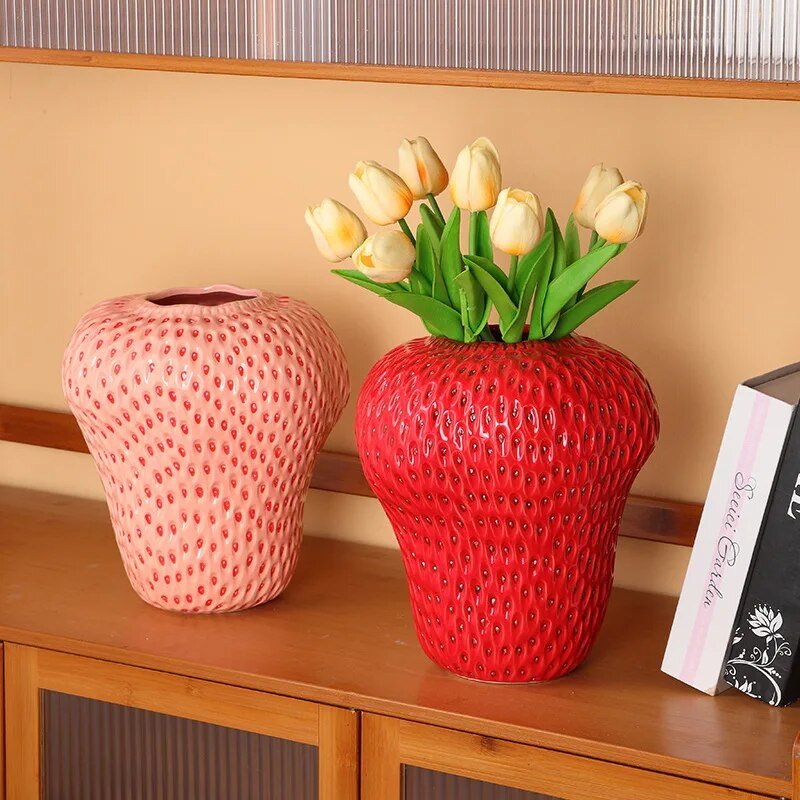 Cartoon strawberry ceramic vase with vibrant colors for kids' room decor, whimsical design ideal for flower arrangement.