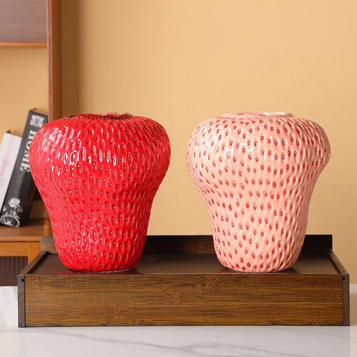 Cartoon strawberry ceramic vase with vibrant colors for kids' room decor, whimsical design ideal for flower arrangement.
