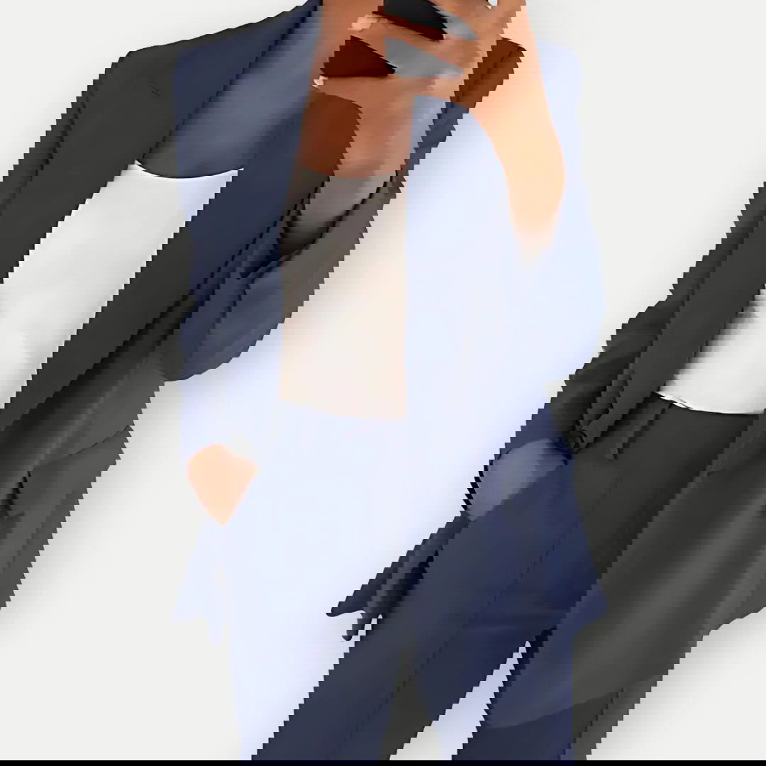 Chic women's tailored blazer and trouser set, elegant business attire with a modern fit, ideal for office or formal events.