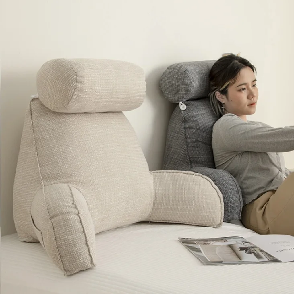 "Deluxe backrest pillow with arms and headrest in cream, featuring a soft-touch finish and side pocket for added convenience.
