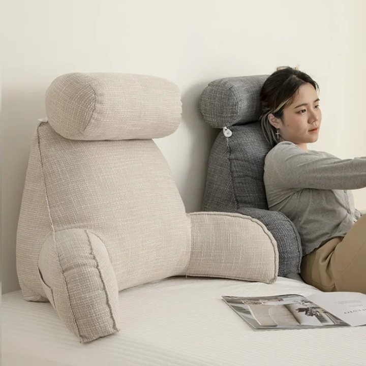 "Deluxe backrest pillow with arms and headrest in cream, featuring a soft-touch finish and side pocket for added convenience.