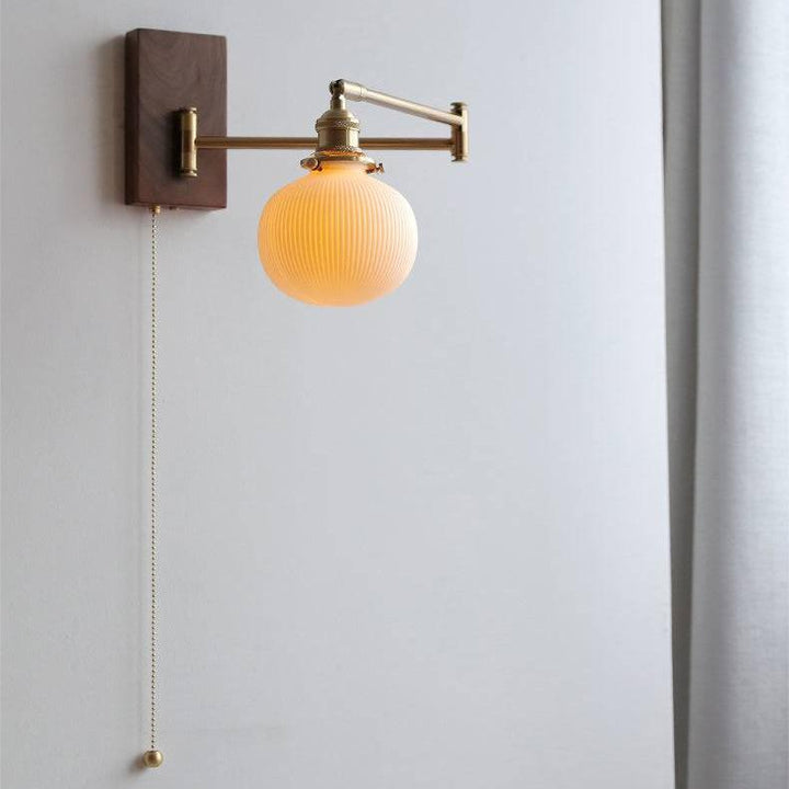 "Elegant ceramic wall lamp with wooden plate, featuring a modern design in cylinder or globe lampshade for stylish interiors.