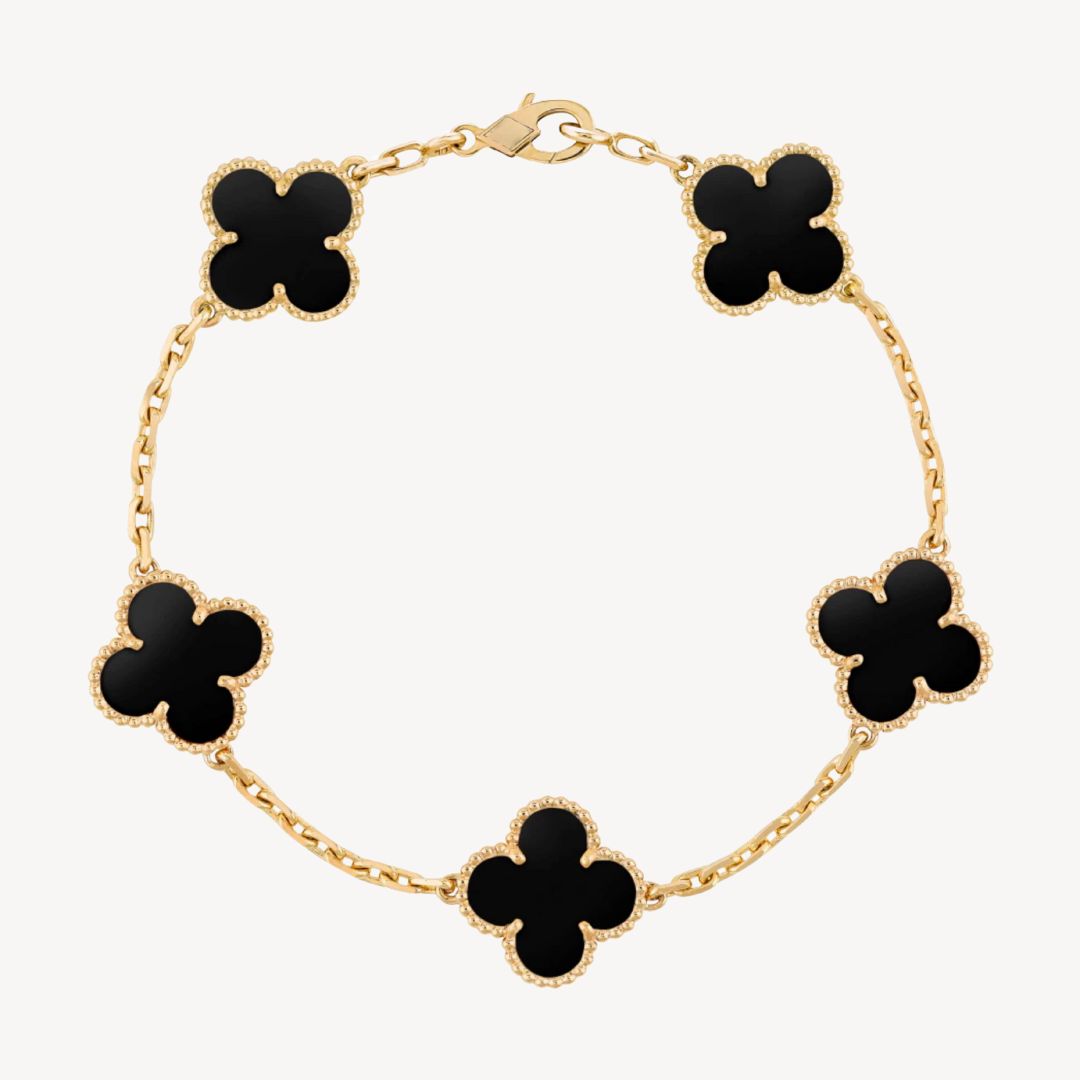 Elegant clover charm bracelet with polished black agate inlays and a gold and silver-tone chain for sophisticated style.