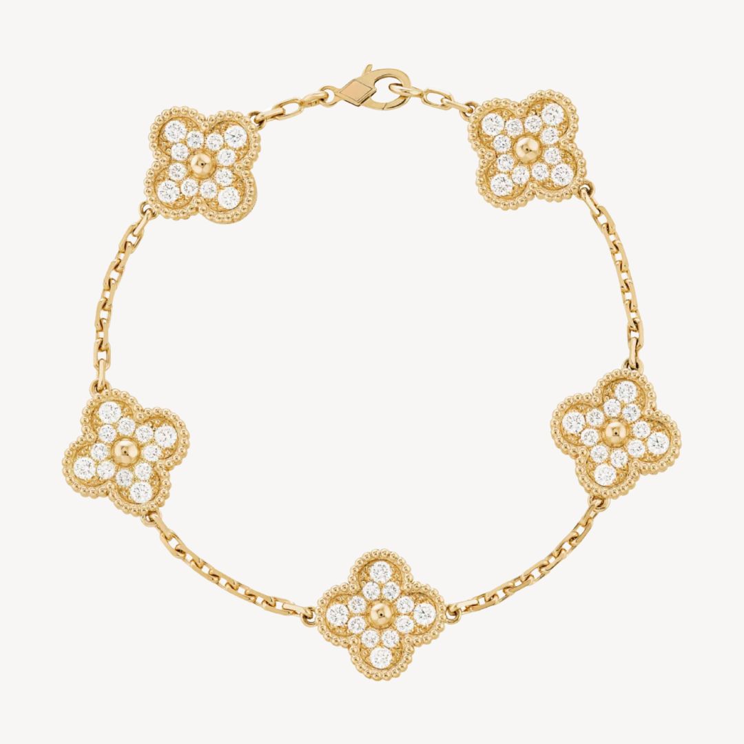 Elegant clover charm bracelet with polished black agate inlays and a gold and silver-tone chain for sophisticated style.