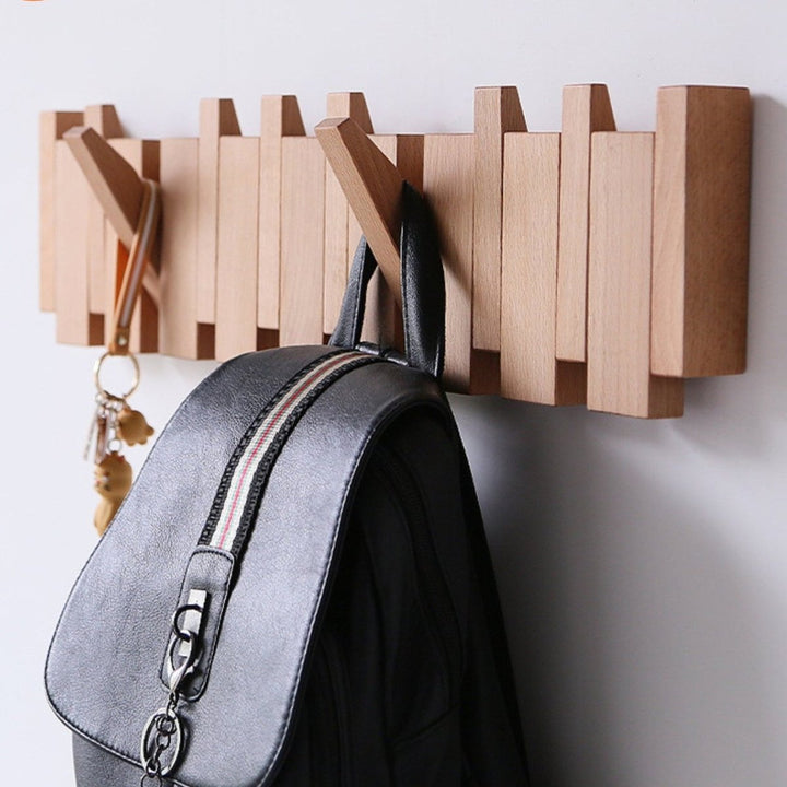 "Elegant handmade wooden piano coatrack front view, showcasing unique piano key design and quality craftsmanship in home deco
