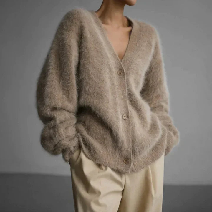 "Elegant women's cashmere cardigan in soft grey, showcasing a luxurious knit texture for ultimate softness and comfort."