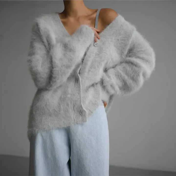 "Elegant women's cashmere cardigan in soft grey, showcasing a luxurious knit texture for ultimate softness and comfort."