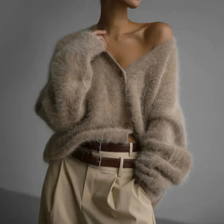 "Elegant women's cashmere cardigan in soft grey, showcasing a luxurious knit texture for ultimate softness and comfort."