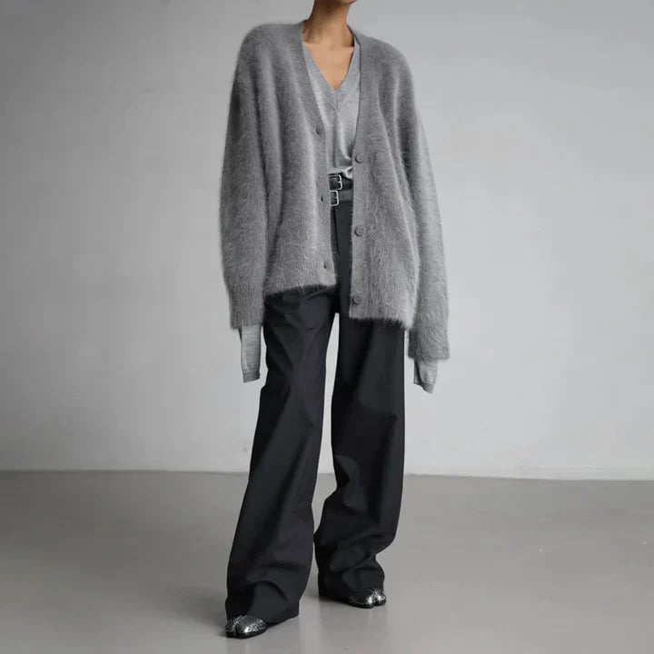 "Elegant women's cashmere cardigan in soft grey, showcasing a luxurious knit texture for ultimate softness and comfort."