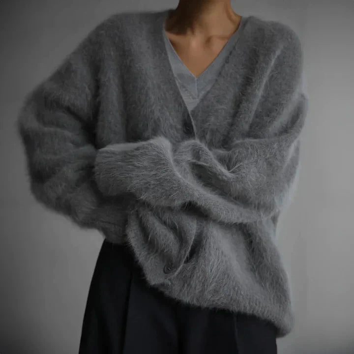 "Elegant women's cashmere cardigan in soft grey, showcasing a luxurious knit texture for ultimate softness and comfort."
