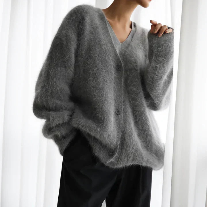 "Elegant women's cashmere cardigan in soft grey, showcasing a luxurious knit texture for ultimate softness and comfort."