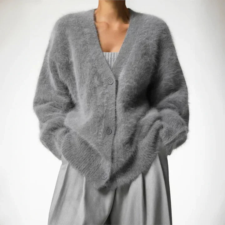 "Elegant women's cashmere cardigan in soft grey, showcasing a luxurious knit texture for ultimate softness and comfort."