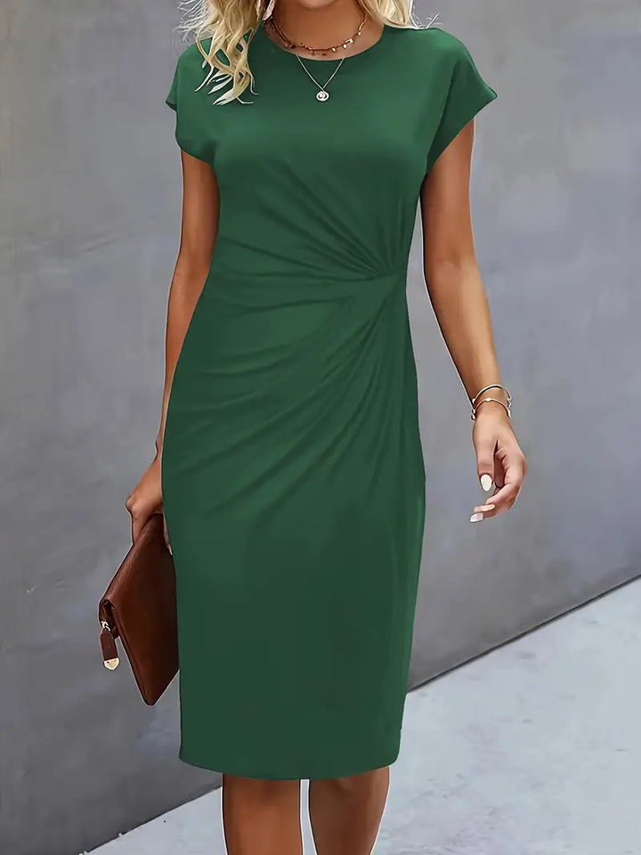 Elegant women's knee-length sheath dress with ruched waist, shown in dark green. Perfect for day-to-night wear.