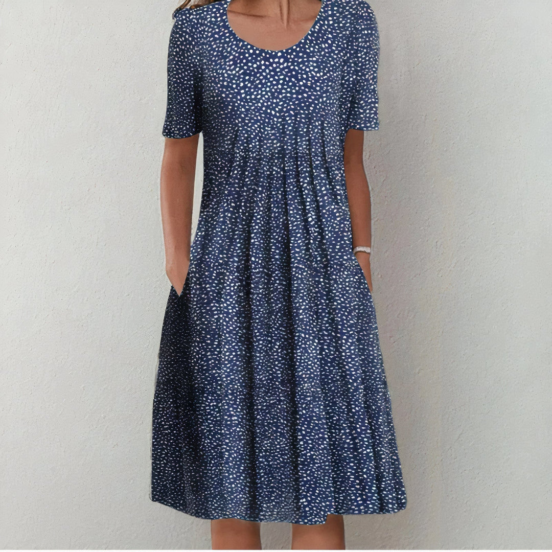 Elegant women's midi dress for spring and summer, featuring a mid-length hem and playful swing, ideal for warm days.