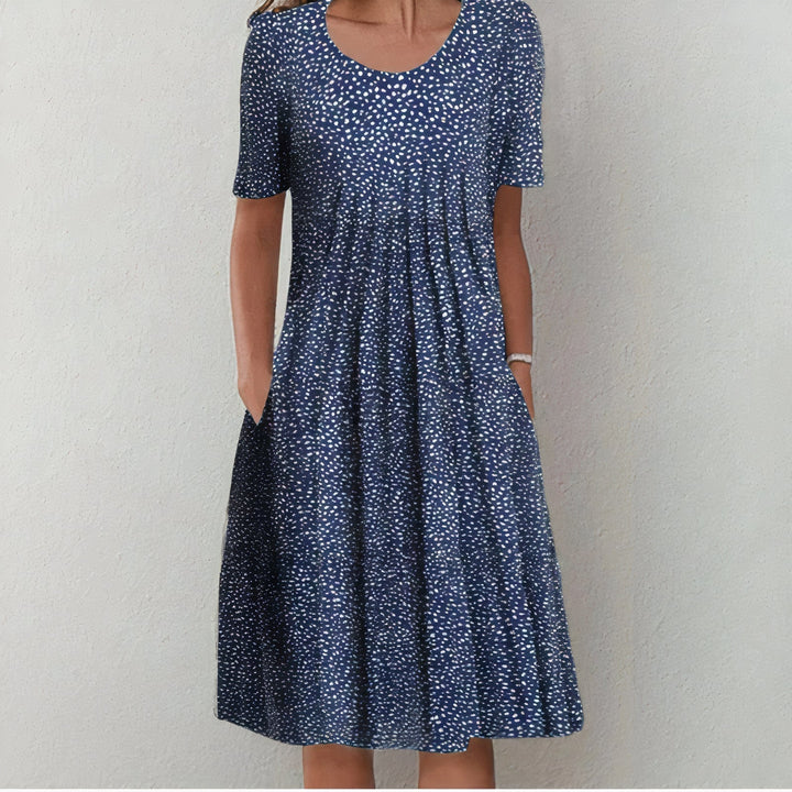 Elegant women's midi dress for spring and summer, featuring a mid-length hem and playful swing, ideal for warm days.
