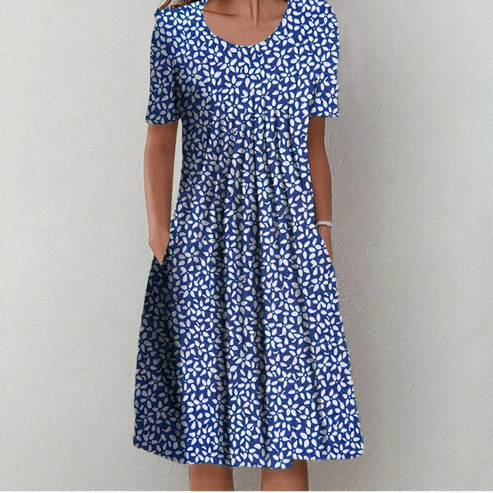 Elegant women's midi dress for spring and summer, featuring a mid-length hem and playful swing, ideal for warm days.