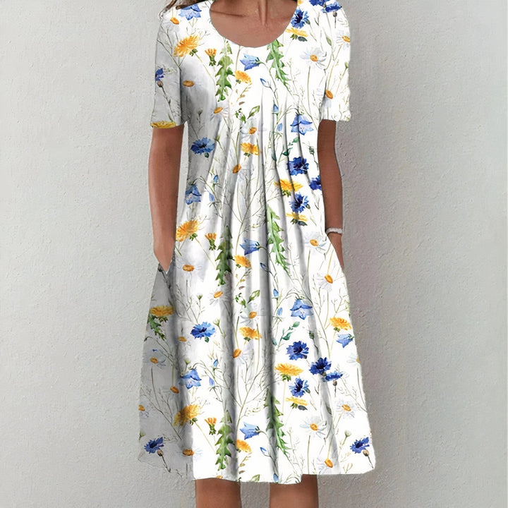 Elegant women's midi dress for spring and summer, featuring a mid-length hem and playful swing, ideal for warm days.