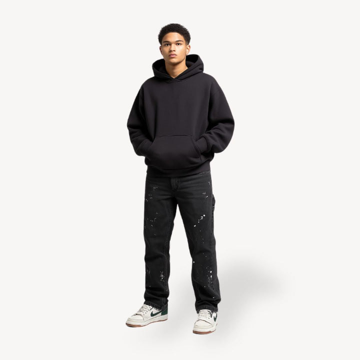 "Front view of men's slim fit stacked jeans in black, gray, blue, showing modern streetwear style and extended leg length."