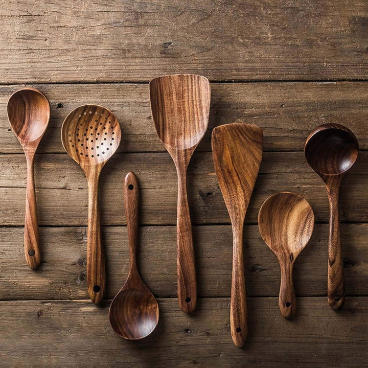 Handcrafted teak wooden cookware set, 7-piece; includes spoons and spatula with unique grain. Perfect for eco-friendly kitche