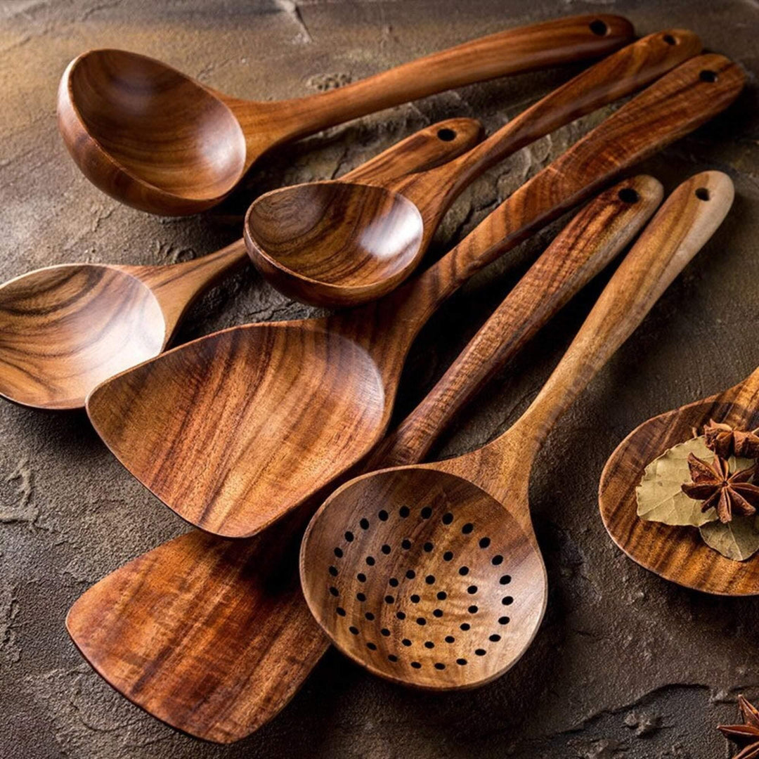 Handcrafted teak wooden cookware set, 7-piece; includes spoons and spatula with unique grain. Perfect for eco-friendly kitche