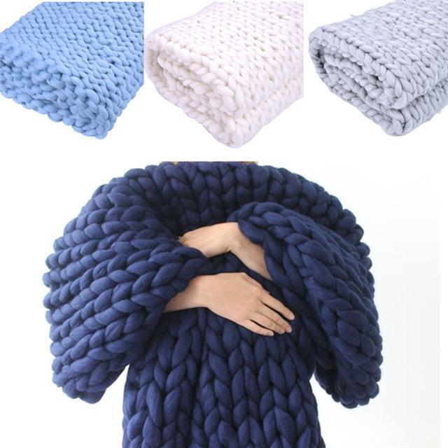 "Handmade chunky knit blanket, super soft texture, vibrant colors draped on furniture, decorative and cozy home accent."
