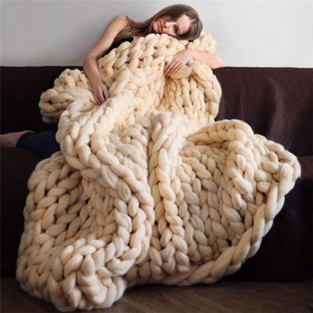 "Handmade chunky knit blanket, super soft texture, vibrant colors draped on furniture, decorative and cozy home accent."