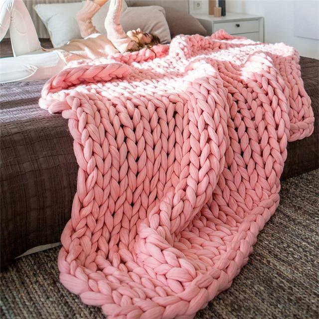 "Handmade chunky knit blanket, super soft texture, vibrant colors draped on furniture, decorative and cozy home accent."