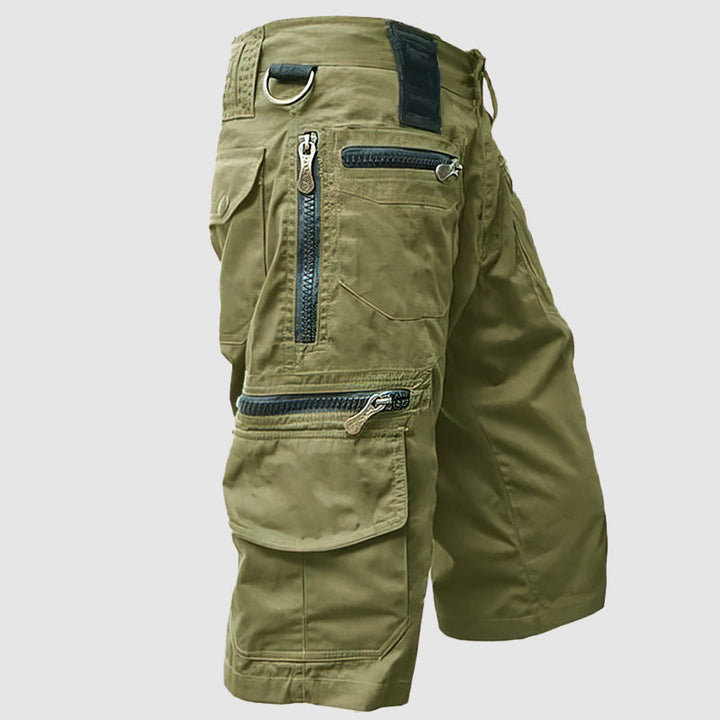 Knee-length men’s cargo shorts in durable cotton with multiple utility pockets, side view for outdoor style and function.
