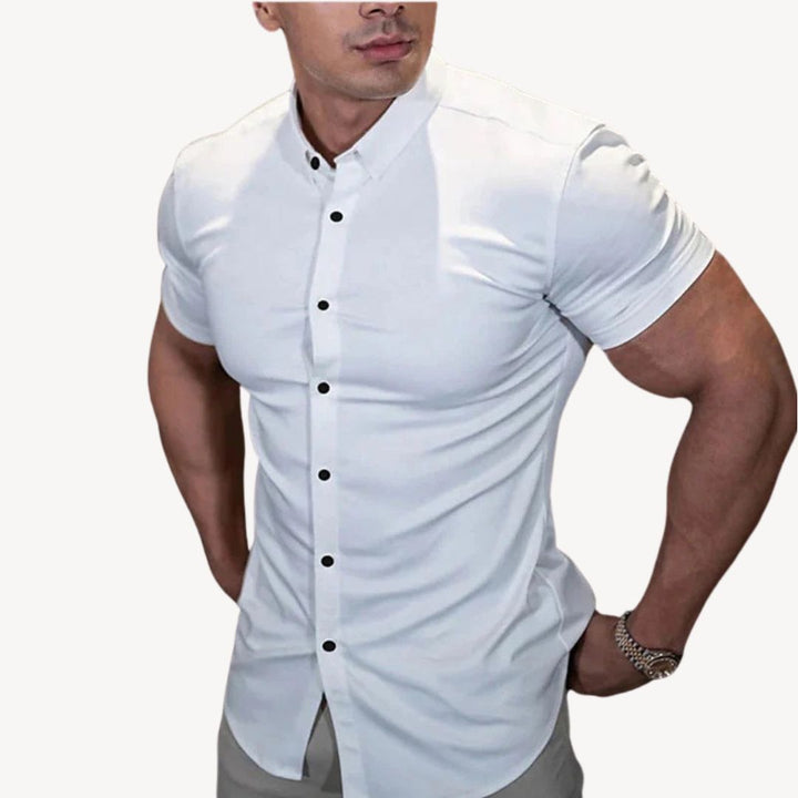 "Men's black muscle fit shirt, cotton spandex, short sleeve, highlighting athletic build, ideal for versatile styling."