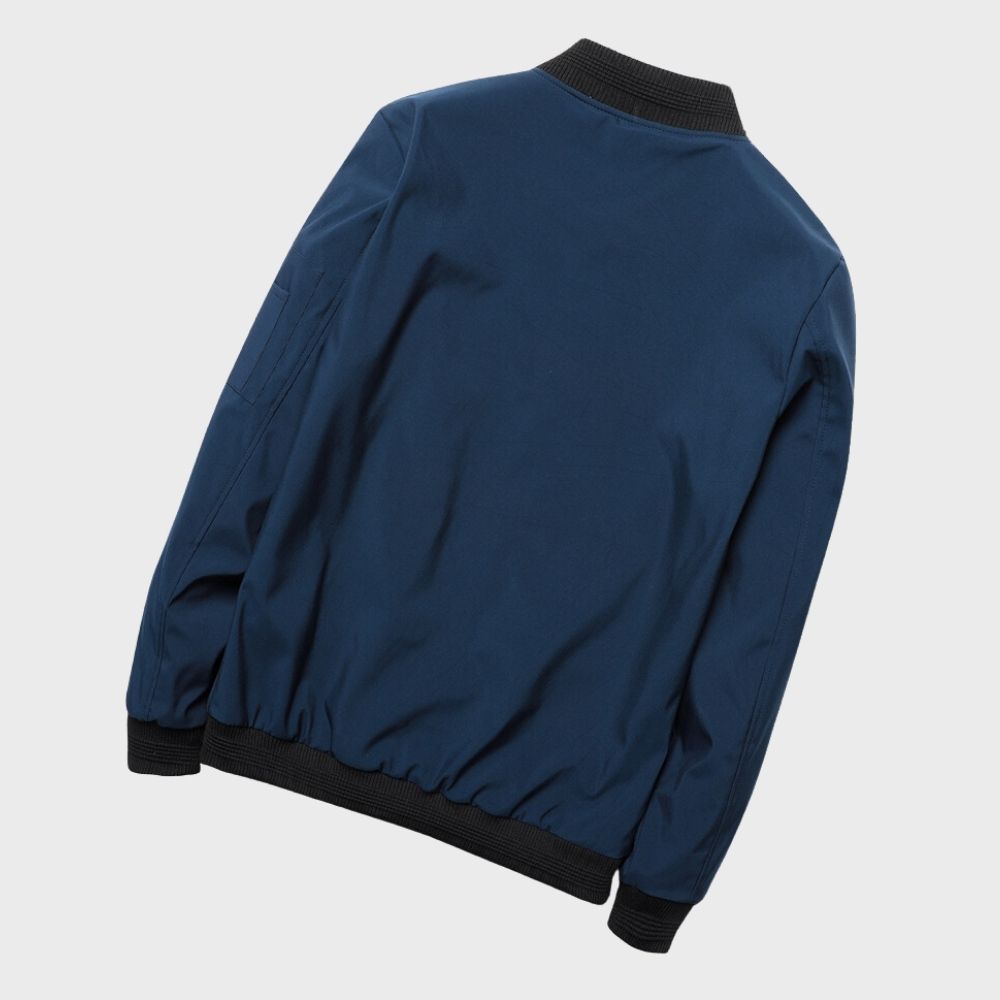 "Men's blue bomber jacket with zipper pockets, stylish fit, lightweight fabric, perfect for cool evenings."