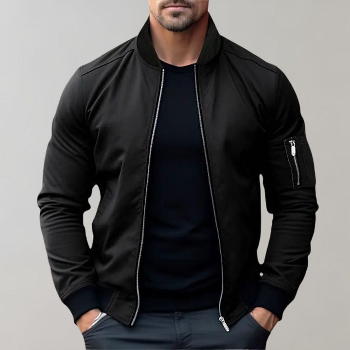 "Men's blue bomber jacket with zipper pockets, stylish fit, lightweight fabric, perfect for cool evenings."