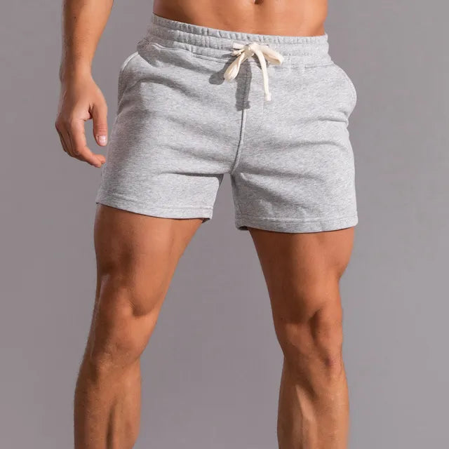 Men's casual shorts with pockets, tailored fit, breathable fabric, light color, ideal for summer outdoor activities.