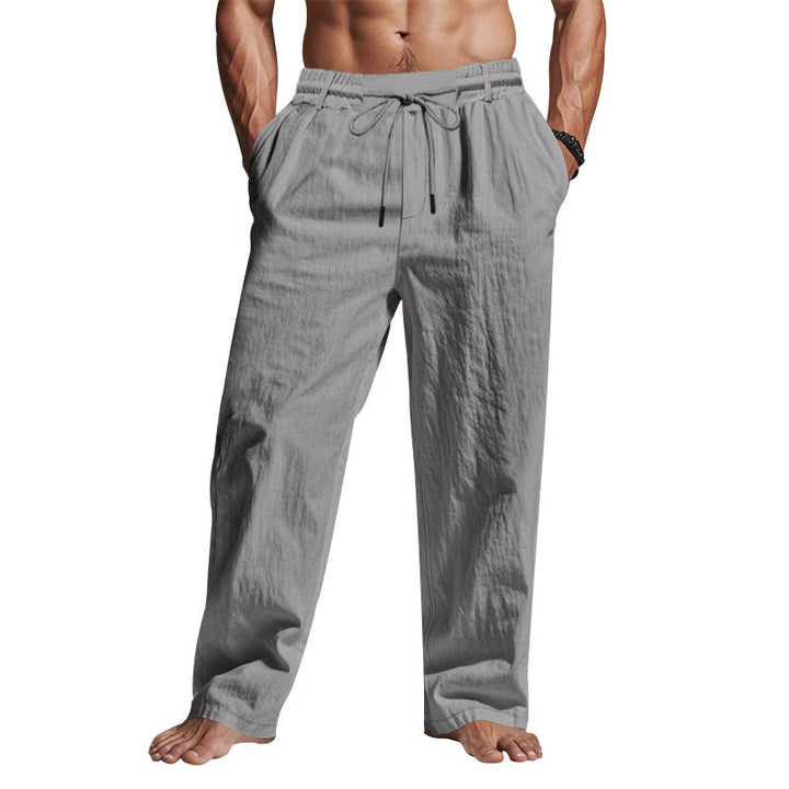 "Men's comfortable linen trousers with drawstring, relaxed fit, breathable fabric, side pockets, ideal for warm days."