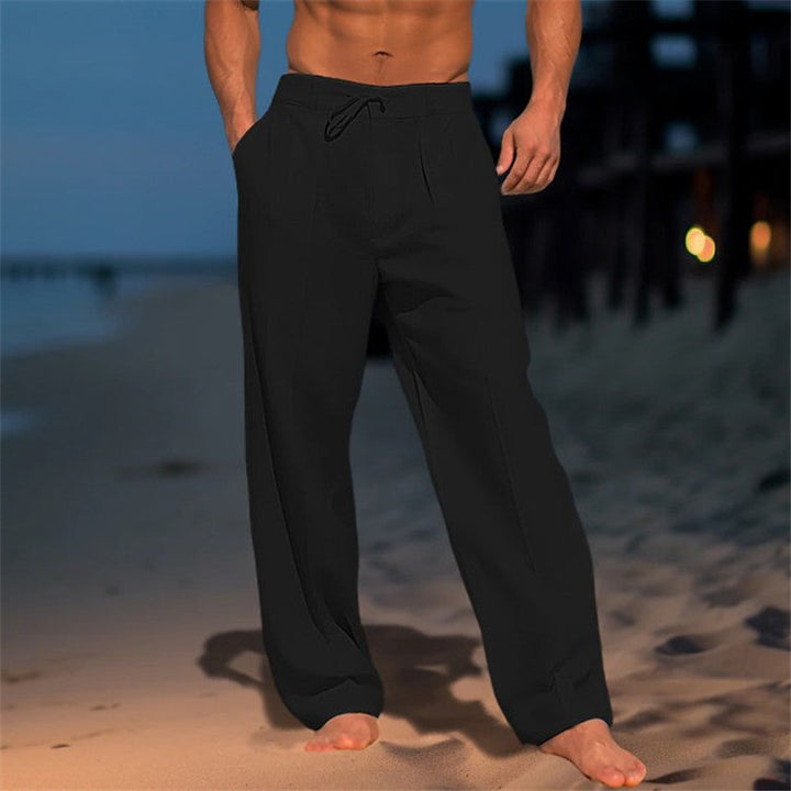 Men's full-length linen trousers with drawstring waist, relaxed fit, and pleated front, ideal for casual wear in warm weather