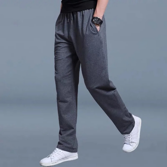 Men's jogging pants with elastic waist, tapered fit, cuffed ankles, and pockets, perfect for comfort and style.