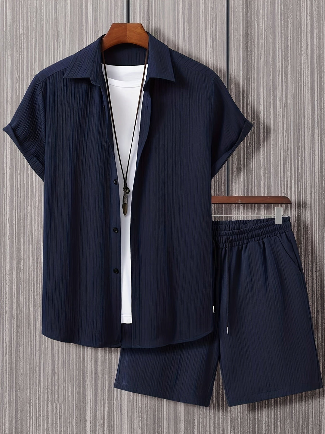 Men's navy blue button-up shirt and shorts set, relaxed fit, notched collar, drawstring waist, effortless style.