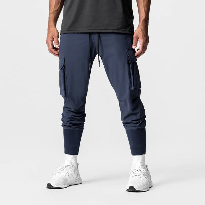 "Men's quick-dry cargo joggers, lightweight with multiple pockets, elastic cuffs, urban style, navy color, displayed front vi