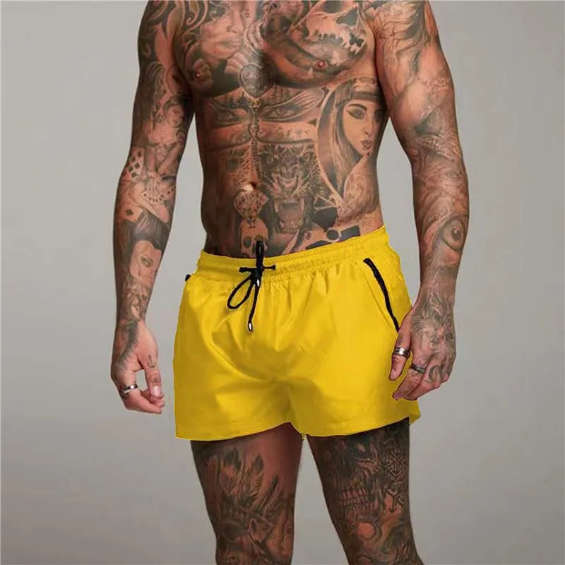 "Men's quick-dry, stretchy swim shorts with pockets in vibrant colors, featuring an elastic waistband and sleek design."