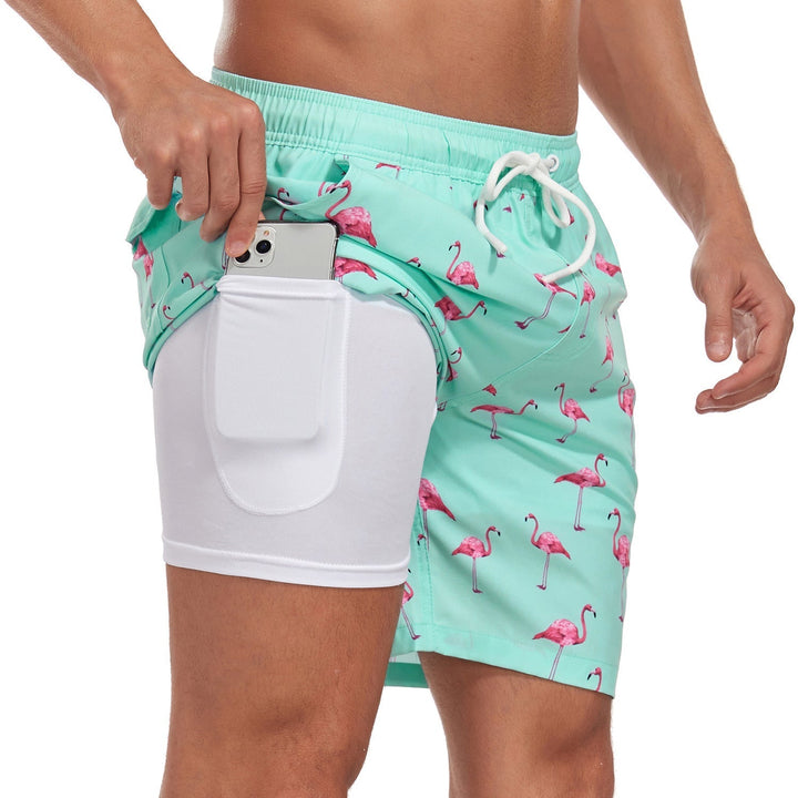 "Men's quick-dry swim shorts with inner compression, bold tropical print, two-tone detail, drawstring waist for secure fit."
