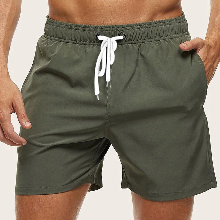 "Men's quick-dry swim trunks with trendy design, elastic waistband, colorful patterns, ideal for beach or pool activities."