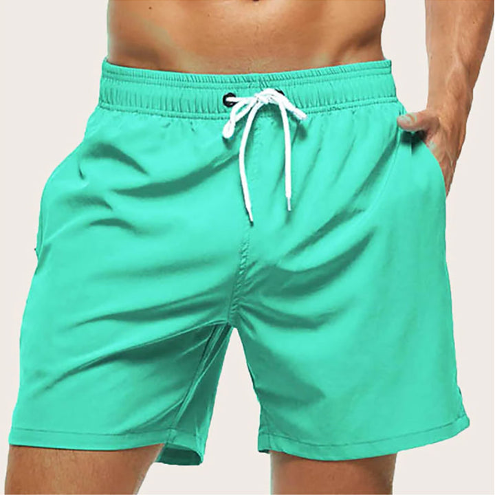 "Men's quick-dry swim trunks with trendy design, elastic waistband, colorful patterns, ideal for beach or pool activities."