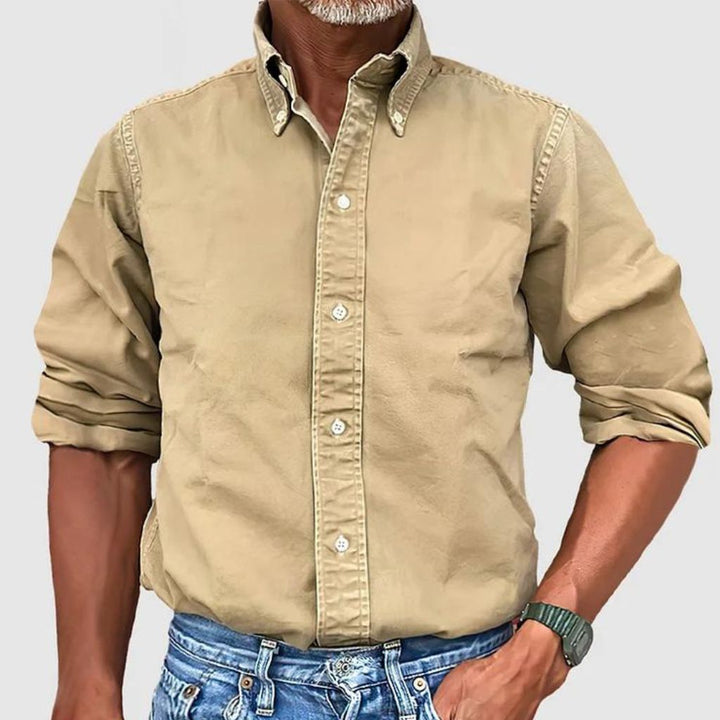"Men's regular fit long-sleeve button-down shirt with classic collar, rolled cuffs, and durable polyester fabric."