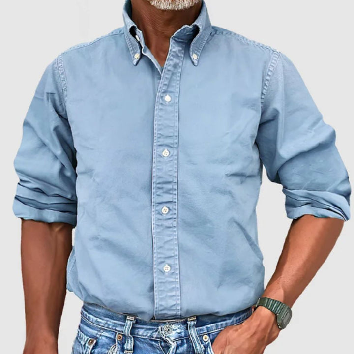 "Men's regular fit long-sleeve button-down shirt with classic collar, rolled cuffs, and durable polyester fabric."