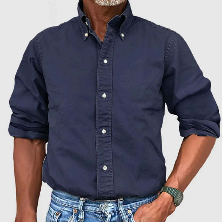 "Men's regular fit long-sleeve button-down shirt with classic collar, rolled cuffs, and durable polyester fabric."