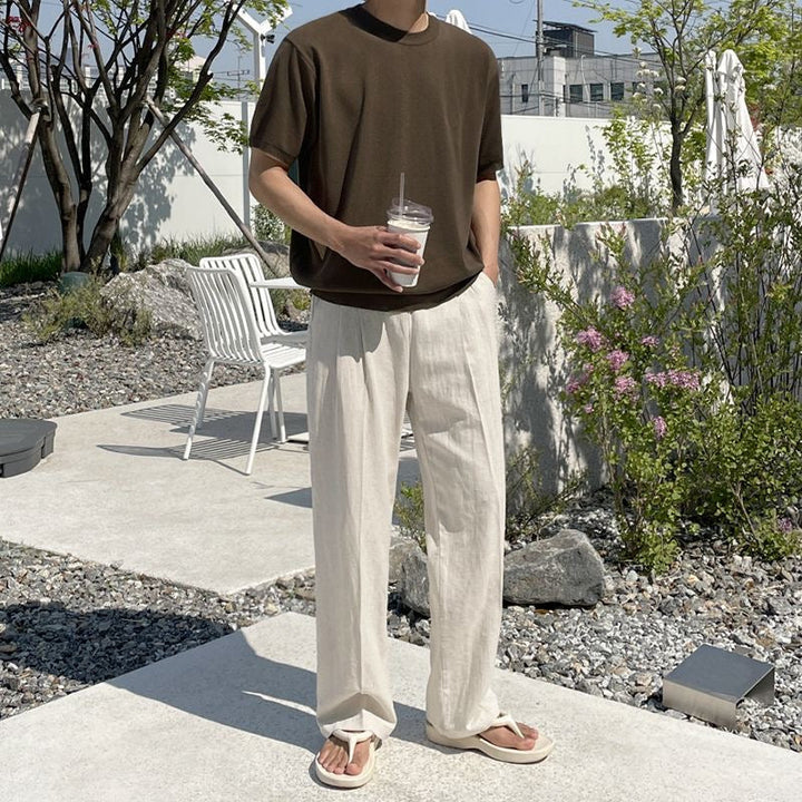 "Men's relaxed fit linen pants in beige, front view, lightweight fabric, perfect for casual and refined occasions."