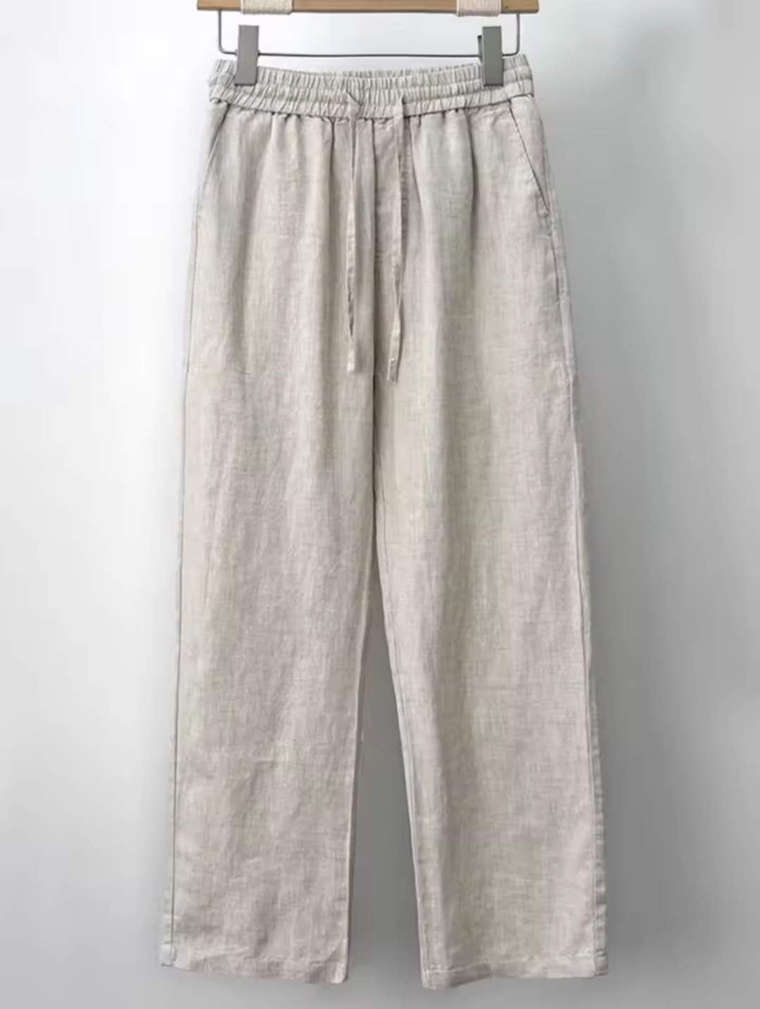 "Men's relaxed fit linen pants in beige, front view, lightweight fabric, perfect for casual and refined occasions."
