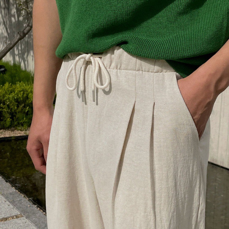 "Men's relaxed fit linen pants in beige, front view, lightweight fabric, perfect for casual and refined occasions."