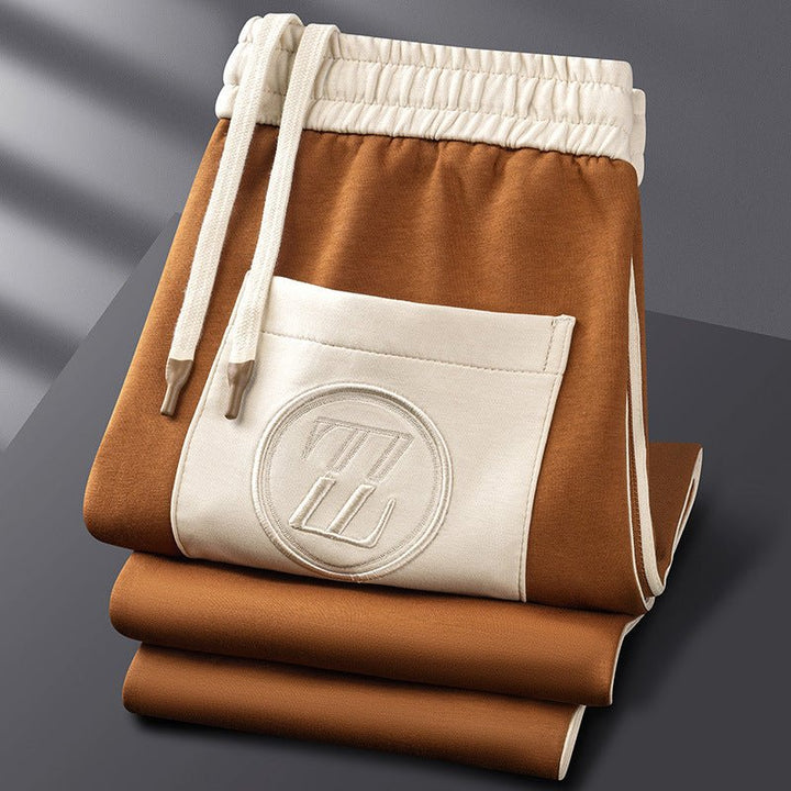 "Men's sporty tracksuit set lycra fabric, sleek lines, stripe accents, tailored fit, showcasing athletic physique."