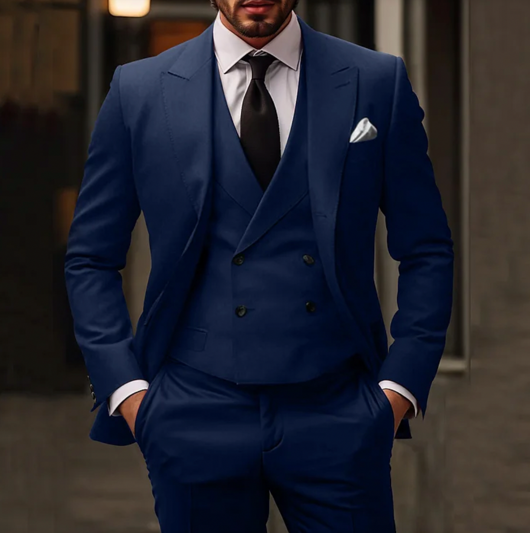 Men's tailored suit with single-breasted jacket, double-breasted vest, and slim trousers in formal stylish design.